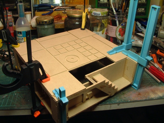 Assembled tile after gluing, with clamps to keep everything together